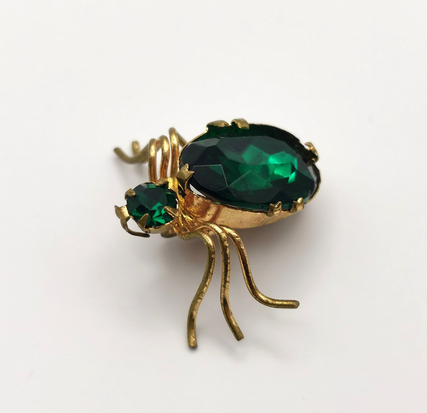 Antique gilt metal spider brooch, Emerald green paste